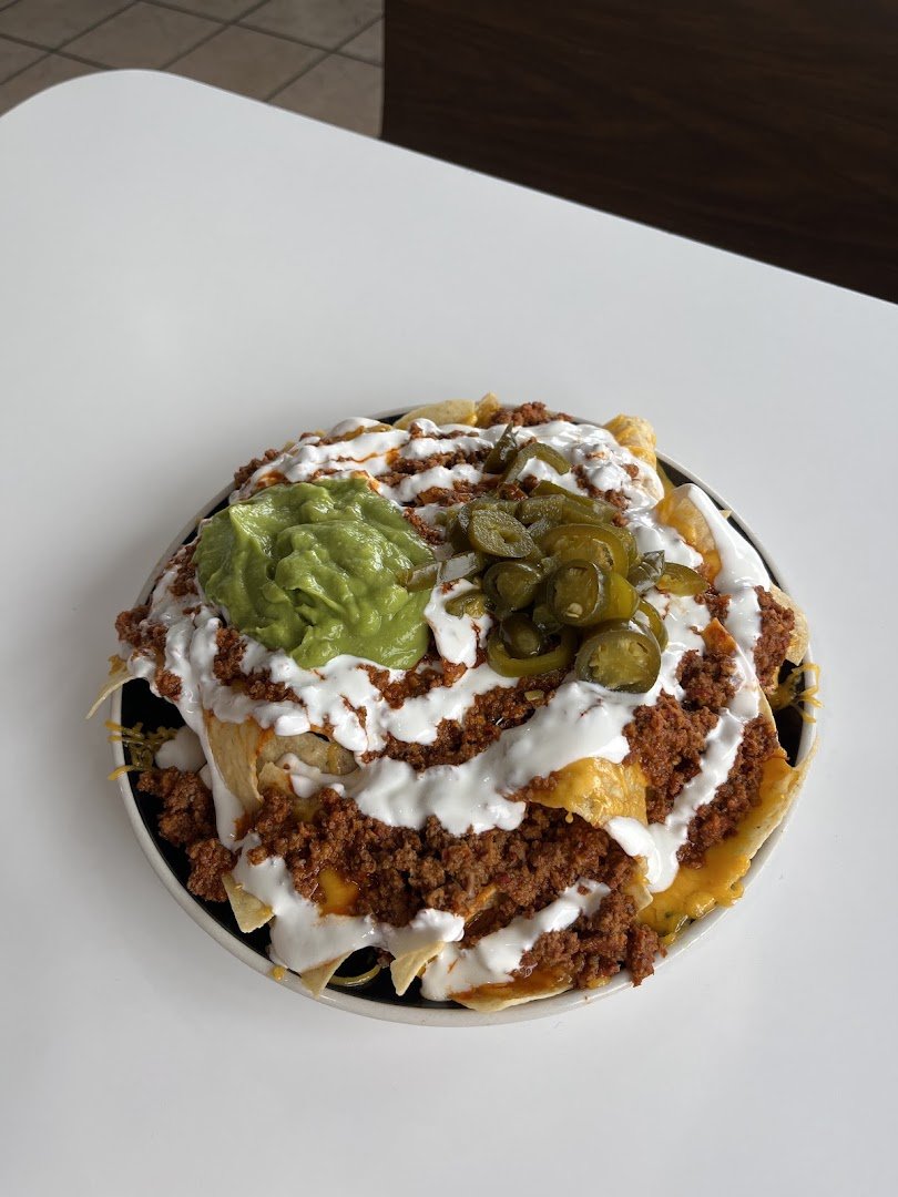 Colorful plates of Mexican food on a table.